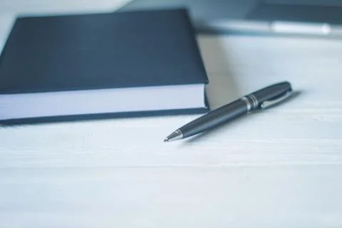 Pen and a notebook at the workplace Stock Photos