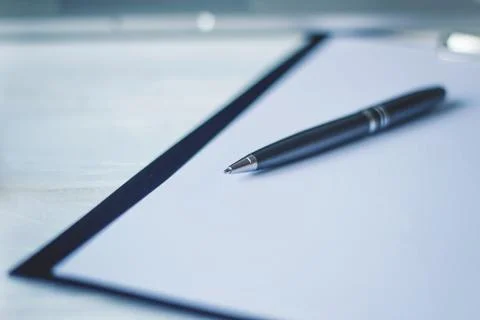 Pen and a notebook at the workplace Stock Photos