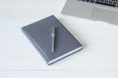 Pen and a notebook at the workplace Stock Photos