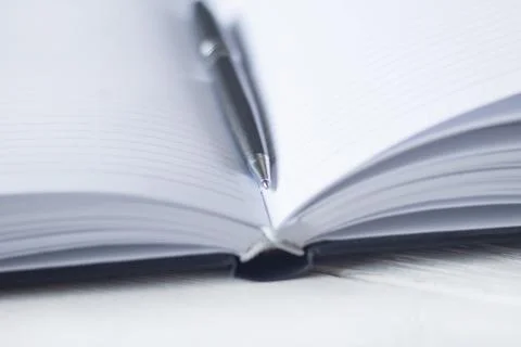 Pen and a notebook at the workplace Stock Photos