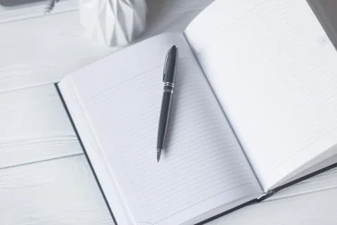Pen and a notebook at the workplace Stock Photos