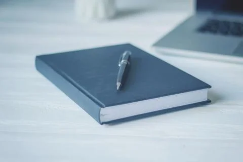 Pen and a notebook at the workplace Stock Photos