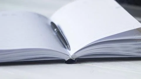 Pen and a notebook at the workplace Stock Photos