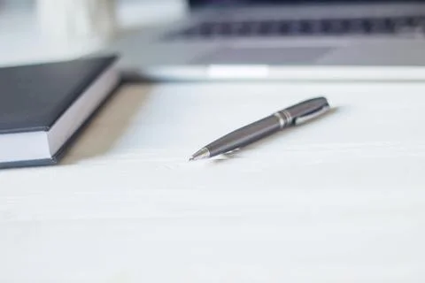 Pen and a notebook at the workplace Stock Photos