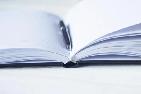 Pen and a notebook at the workplace Stock Photos