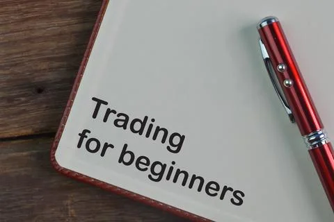 Pen and notebook written with text TRADING FOR BEGINNERS Stock Photos