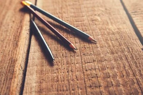Pen and pencils on vintage wooden table Stock Photos