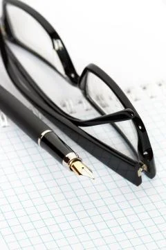 Pen and spectacles Stock Photos