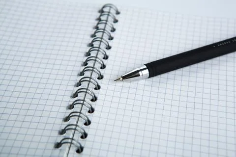 Pen on the checkered paper notebook Stock Photos