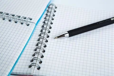 Pen on the checkered paper notebook Stock Photos