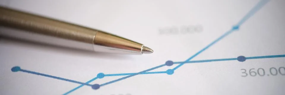 Pen on document with statistics data, graph and chart Stock Photos