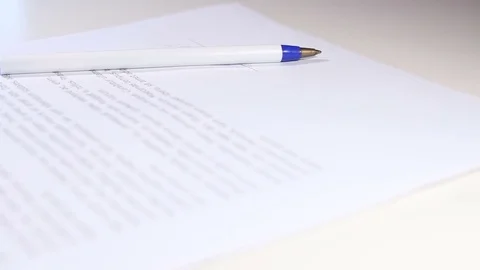 Pen with document on white table. Stock Footage 83260427