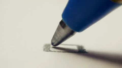 Pen draws a check mark on a white background paper, macro shot Video stock 131115926