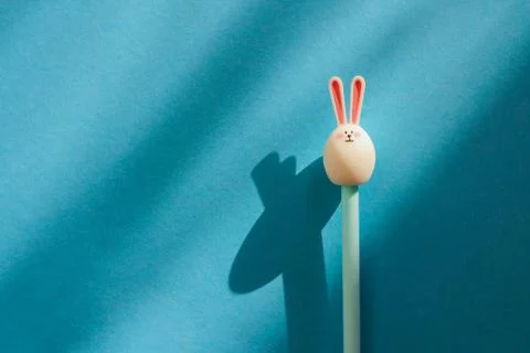 Pen-hare on a blue background with shadows. Stock Photos