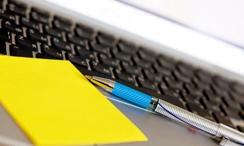 Pen on the keyboard Stock Photos