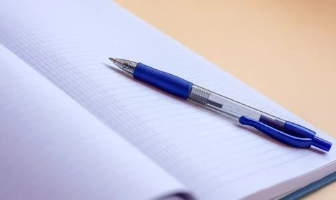 A pen lies on an open notebook with empty pages Stock Photos