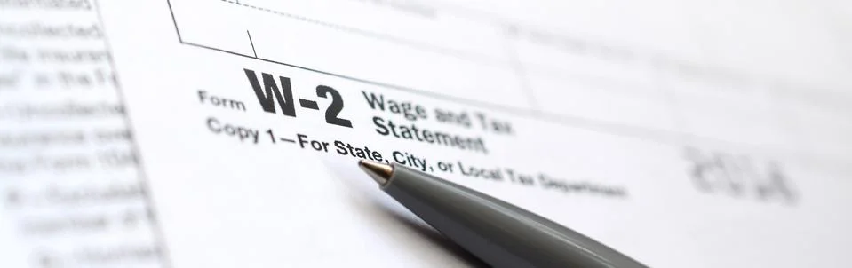 The pen lies on the tax form W-2 Wage and Tax Statement. The time to pay taxe Stock Photos