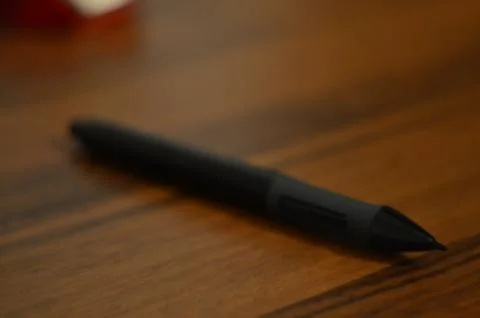 Pen lying on a brown table Stock Photos
