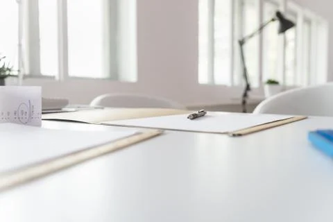 Pen lying on a document in an open folder on an office desk Stock Photos