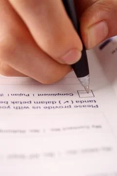 Pen marking check boxes about the compliment Stock Photos