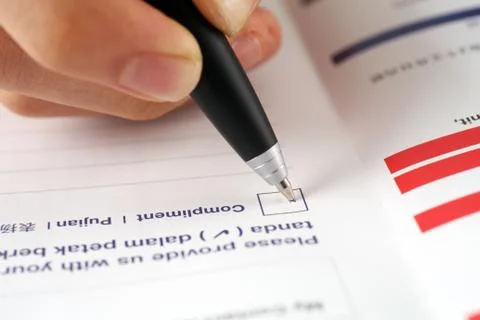 Pen marking check boxes, about compliment Foto stock