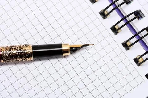 Pen on note books Stock Photos