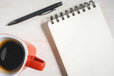 A pen A notebook and a cup of coffee Stock Photos
