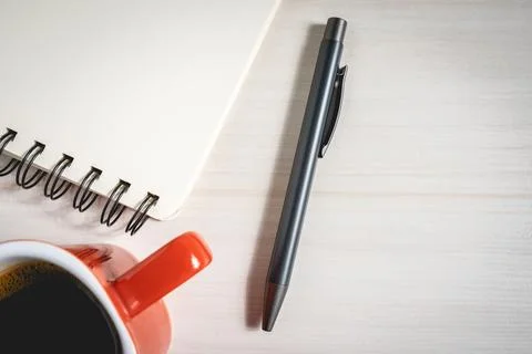 A pen A notebook and a cup of coffee Stock Photos
