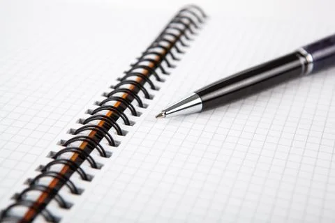 Pen on a notebook into a cell Stock-Fotos
