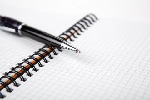 Pen on a notebook into a cell Stock Photos