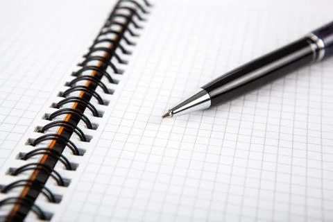 Pen on a notebook into a cell Stock Photos