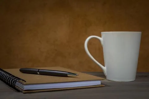 Pen on Notebook with Coffee Cup Stock Photos