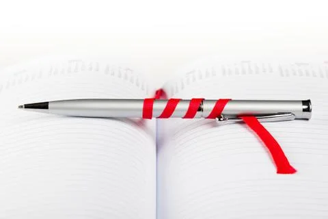 Pen on notebook with red string Stock Photos