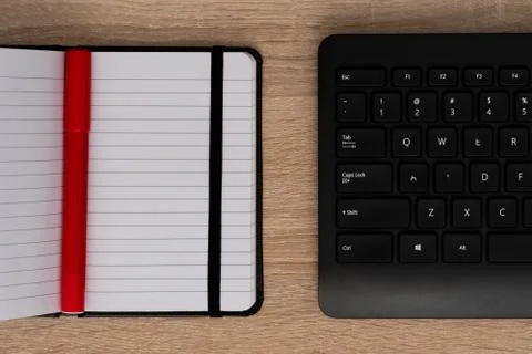 Pen on open notebook with black keyboard Stock Photos