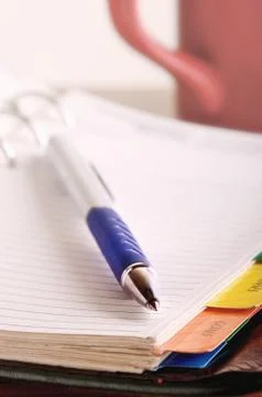 Pen on open notebook Stock Photos