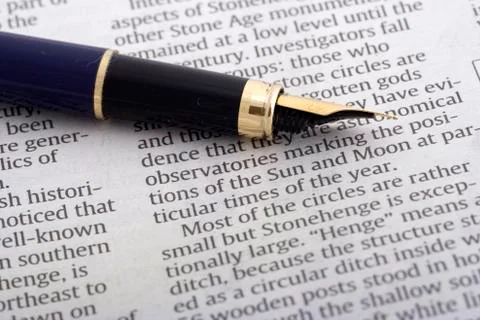 Pen Over Newspaper Stock Photos