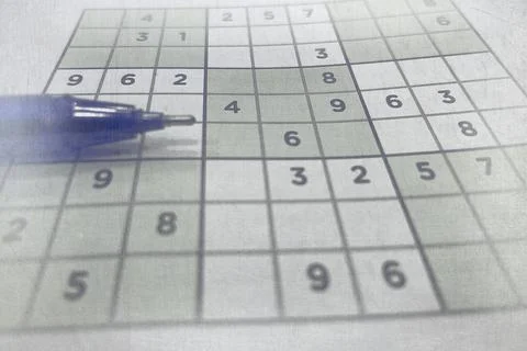 Pen on Partially Solved Sudoku Puzzle Stock Photos