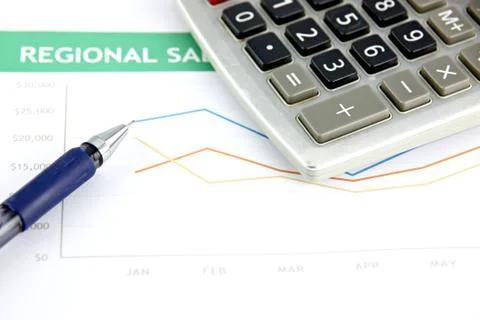 Pen resting on a sales graph. Stock Photos