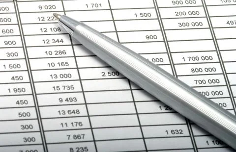 Pen on sheet with figures. Stock Photos