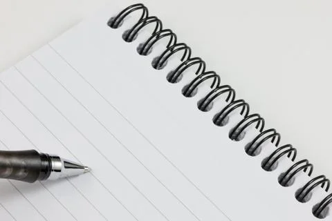 Pen on a spiral notebook Stock Photos