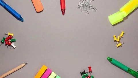 Pen, sticky note, marker, eraser, push pins, paperclip on gray with copy space 스톡 동영상 123808743