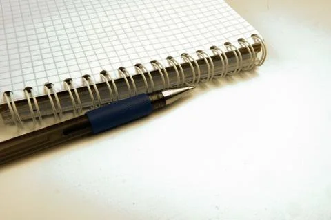 The pen is on the table next to the notebook Stock Photos