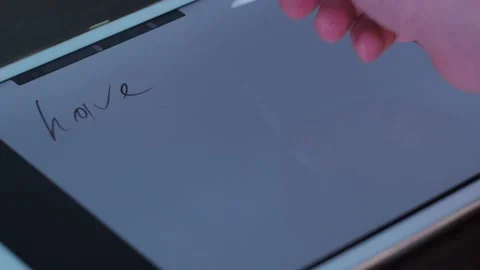Pen writes text on the tablet. have a good time Stock Footage 146794135