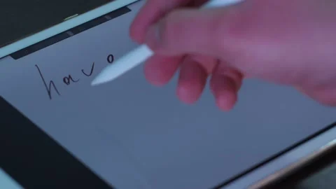 Pen writes text on the tablet. have a good holiday Stock Footage 146857804