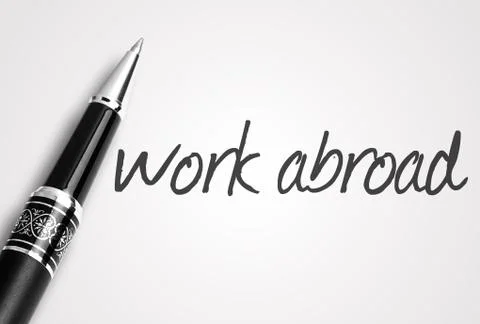 Pen writes work abroad on white blank paper Stock Photos