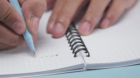 A Pen Writing Basic Math Problems in an Exercise Book Stock Footage 337880759