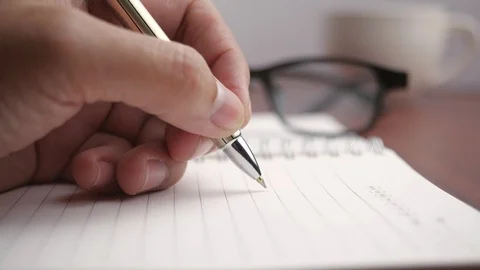 Pen writing on a book in 4K resolution Stock-Footage 126953167