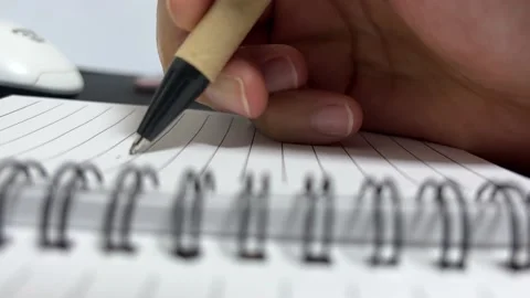 Pen-writing hand in a notebook Stock Footage 194494136
