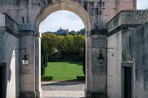 Pena Palace on hill framed by ancient stone arch in Sintra, Portugal Stock Photos