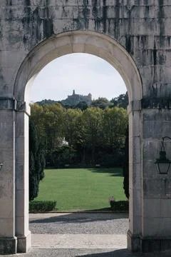 Pena Palace on hill framed by ancient stone arch in Sintra, Portugal Foto stock
